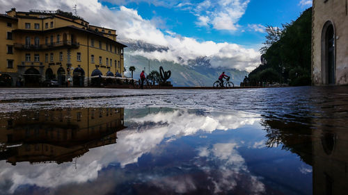 Panoramic view of buildings against cloudy sky