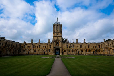 The queens college against cloudy sky