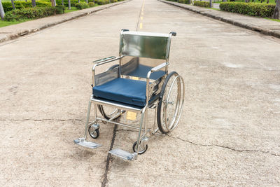 High angle view empty wheelchair on road