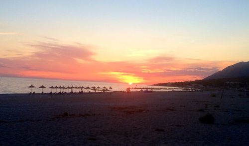 Scenic view of beach against sky during sunset