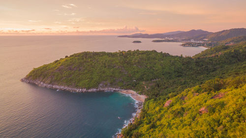 High angle view of bay against sky at sunset
