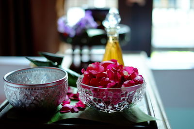 Close-up of roses in glass vase on table