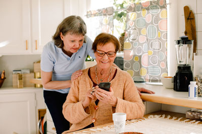 Woman sitting on chair at home