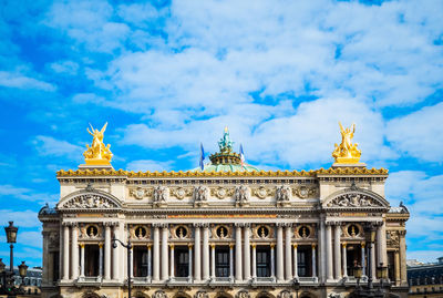 Building facade against clouds