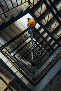 High angle view of worker standing on railing by staircase