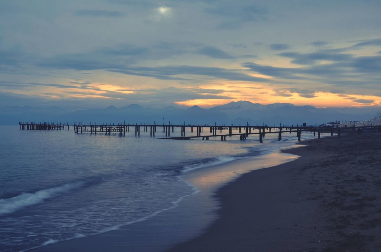 water, sea, sunset, sky, tranquil scene, tranquility, scenics, pier, beach, beauty in nature, cloud - sky, nature, silhouette, shore, idyllic, horizon over water, cloud, built structure, sand, dusk