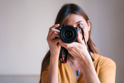 Close-up of woman photographing with camera