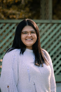 Portrait of smiling young woman standing outdoors