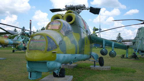 Airplane on field against sky