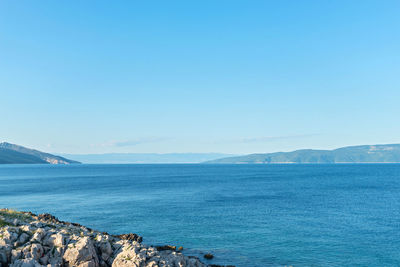 Scenic view of sea against clear blue sky