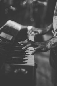 Close-up of hands playing piano