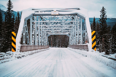 Snow covered road against sky