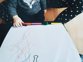 High angle view of woman standing on table