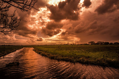 Scenic view of land against sky during sunset