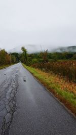 Empty road along countryside landscape