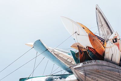 Low angle view of various boats against sky