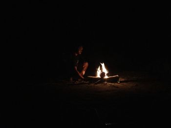 Bonfire on wooden log at night