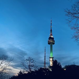 Low angle view of communications tower against blue sky