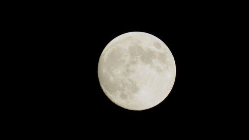 Low angle view of full moon against sky at night