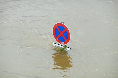 High angle view of warning sign on lake