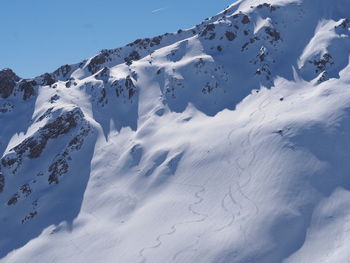 Scenic view of snow covered mountains against sky