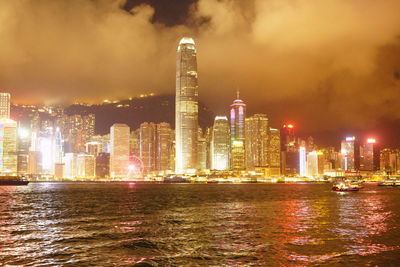 Illuminated buildings against sky at night