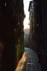 Alley amidst buildings against sky