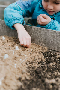 Midsection of boy playing with soil