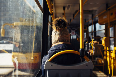 Rear view of man sitting in bus