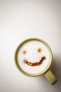 Directly above shot of coffee cup over white background