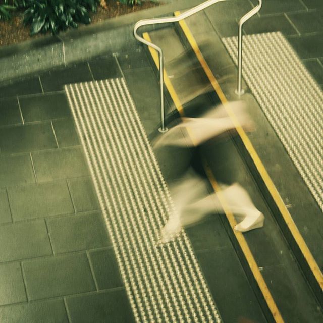 high angle view, shadow, sunlight, street, road, empty, transportation, railing, absence, seat, outdoors, road marking, steps, pattern, day, focus on shadow, in a row, no people, bench, sidewalk