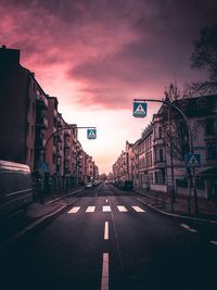 View of road in city against sky during sunset