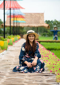 Portrait of a smiling young woman sitting outdoors