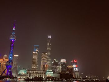 Illuminated buildings in city at night