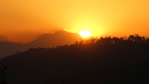 Scenic view of silhouette mountains against sky at sunset