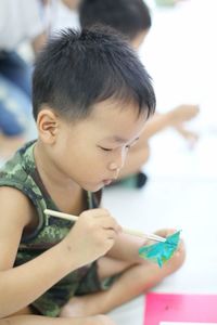 Boy painting object