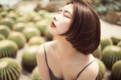 Close-up of young woman looking away outdoors