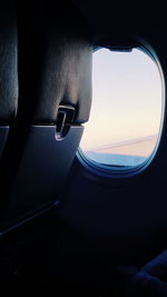 Close-up of airplane wing against sky
