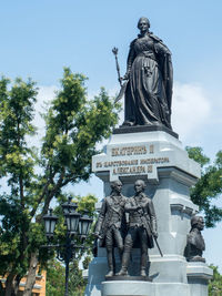Low angle view of statue against sky in park