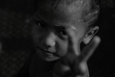 Close-up portrait of boy in darkroom