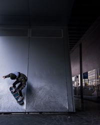 Man skateboarding in room