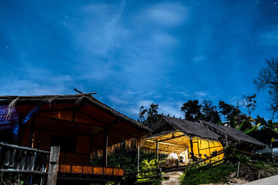 Low angle view of buildings against sky at night