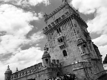 Low angle view of old building against cloudy sky