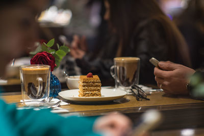 Close-up of woman with drink on table