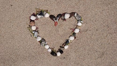 High angle view of heart shape on sand