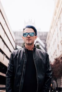 Portrait of mature man wearing sunglasses while standing outdoors