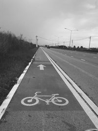 Bicycle lane on road against sky