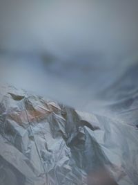 Low angle view of plastic against cloudy sky