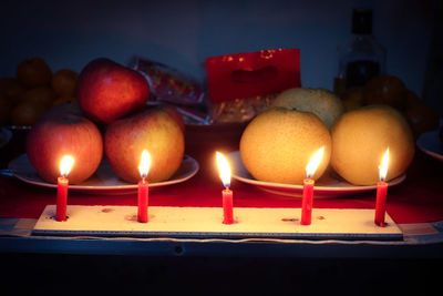 Close-up of candle in darkroom