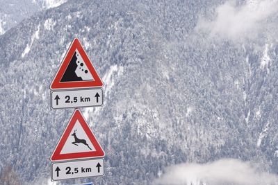 Information sign against mountain during winter